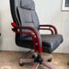 Black leather hydraulic barber chair with chrome accents and adjustable headrest